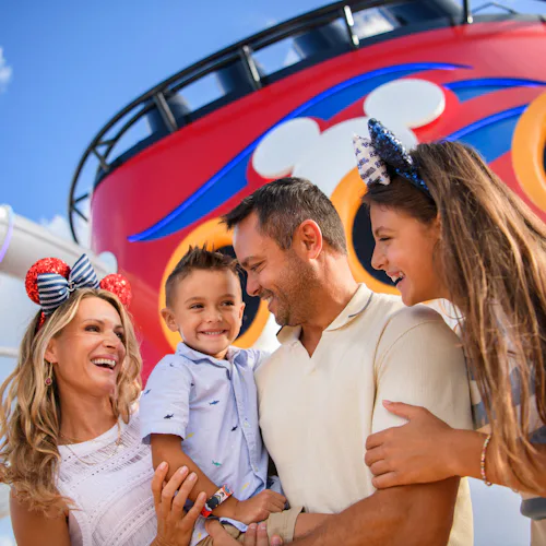 Family on Disney ship with funnel in the background