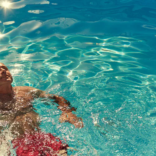 A guest relaxing in a pool on a P&O Cruises ship